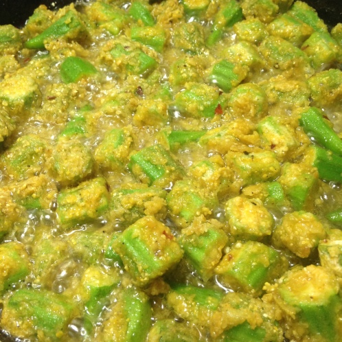 Here's some okra being fried up, with a coating of flour, cornmeal, and lots of Indian spices.  It might be an ugly picture, but it sure was tasty!  Try one of the recipes above for a much healthier alternative.    